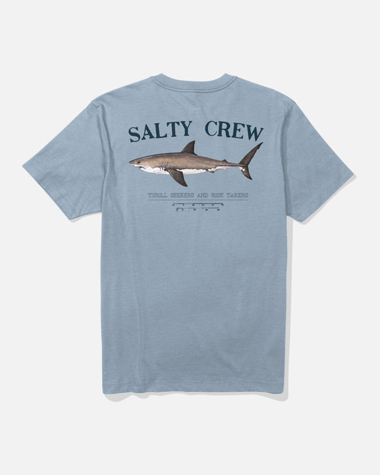 The Salty Crew Bruce Tee in Blue Fog is a light blue combed ringspun cotton t-shirt with a large screenprinted shark graphic and "SALTY CREW" text on the back, plus smaller text and graphics below.