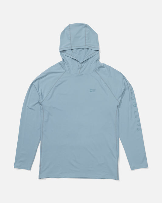 The Salty Crew Apex Perforated Sunshirt in Mineral Blue features long sleeves, a hood, SALTY CREW text on the left sleeve, a chest logo, and breathable UPF 50+ technical knit, shown here laid flat on a white background.