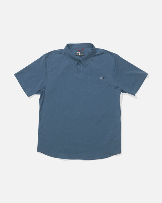 The Salty Crew Drifter UV Polo in Channel Blue features short sleeves, a collar, front buttons, a small chest pocket, and quick-dry fabric, shown laid flat on a plain white background.