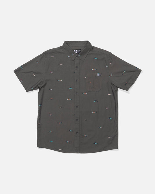 The Crew Button Up - Charcoal is a short-sleeve, button-up shirt in a charcoal gray cotton blend with a front pocket and small multicolored embroidered allover prints, shown on a plain white background.