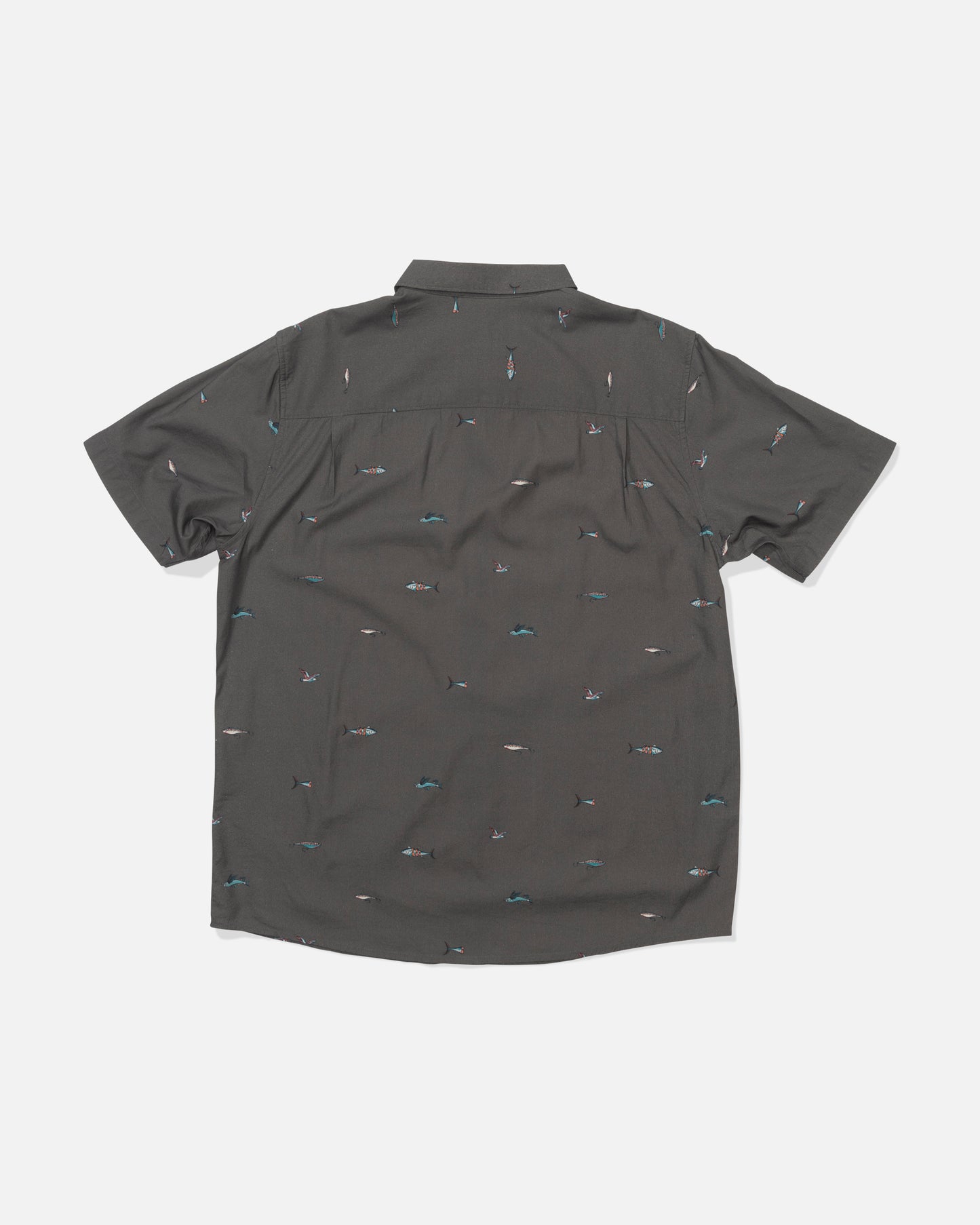 The Crew Button Up - Charcoal is shown laid flat, back facing up. This short-sleeve shirt features an allover print of small, colorful surfers and waves on a dark gray cotton blend fabric.