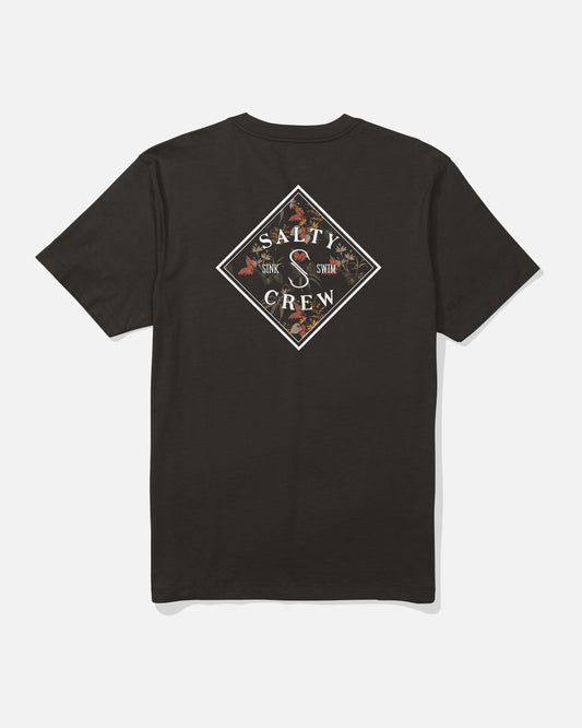 The Salty Crew Tippet Fill Crew Tee in black features a diamond-shaped screenprinted logo on the back with “Salty Crew” and “Sink or Swim” text, accented by detailed floral and leaf artwork. Made from soft combed ringspun cotton for lasting comfort.