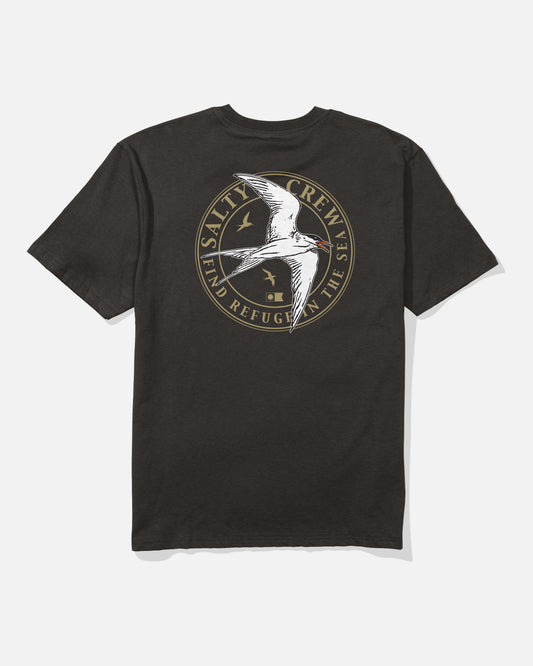 The Tern Original Tee - Black by Salty Crew is a soft, spun cotton t-shirt featuring a large, circular screenprinted logo on the back with a flying seabird, two smaller birds, and the words “SALTY CREW” and “FIND REFUGE IN THE SEA” in gold lettering.