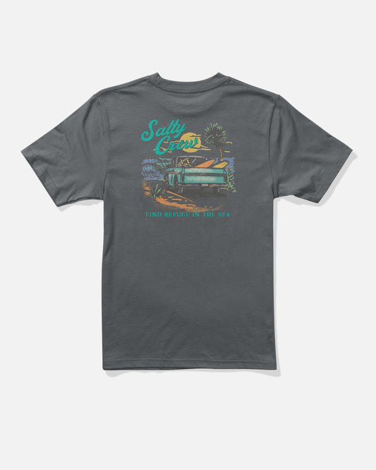 The Salty Crew Truck Bed Boys Tee in charcoal is a dark gray combed ringspun cotton T-shirt with a beach scene screenprinted on the back—featuring a palm tree, waves, and a van—along with the text “Salty Crew” and “Find Refuge in the Sea” in teal and orange.