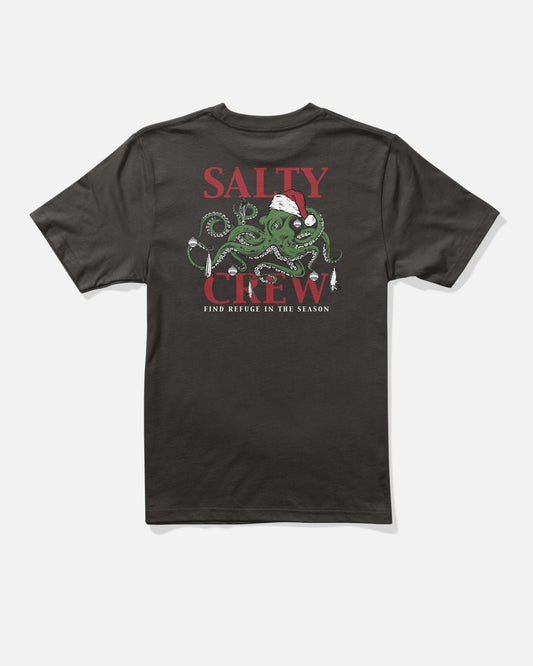 The Salty Crew Inkmas Boys Holiday Tee in black is a 100% cotton shirt with a green octopus in a Santa hat holding fishing gear, red SALTY CREW text, and FIND REFUGE IN THE SEASON—ideal for Holiday 2025.