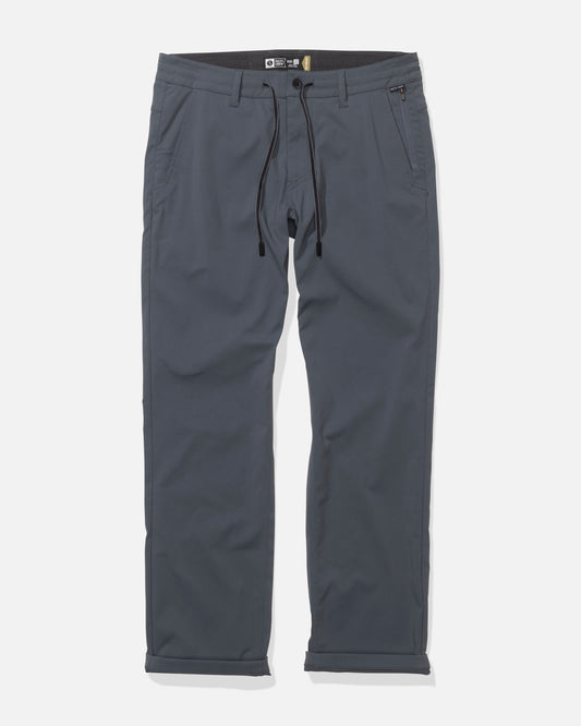 The Salty Crew Transom Tech Pants in Magnet are gray casual pants made from recycled performance fabric, with a drawstring waist, front pockets, belt loops, and a right zippered pocket, shown flat on a white background.