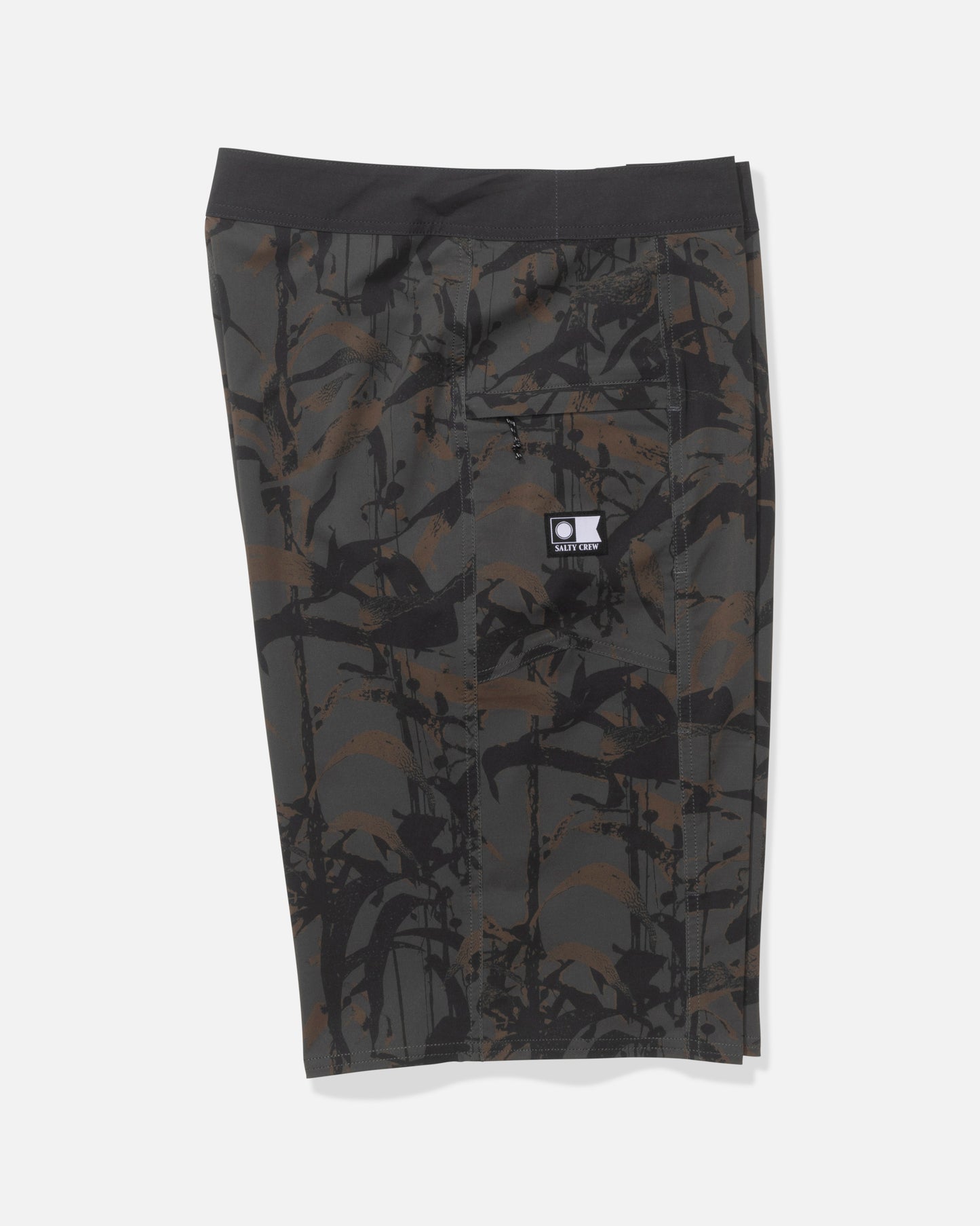 The Salty Crew Flagship 22" Boardshort in Dusty Olive features knee-length, dark camo quick-dry fabric with an abstract black and brown brushstroke pattern, a black waistband, back pocket, and a small white logo patch.
