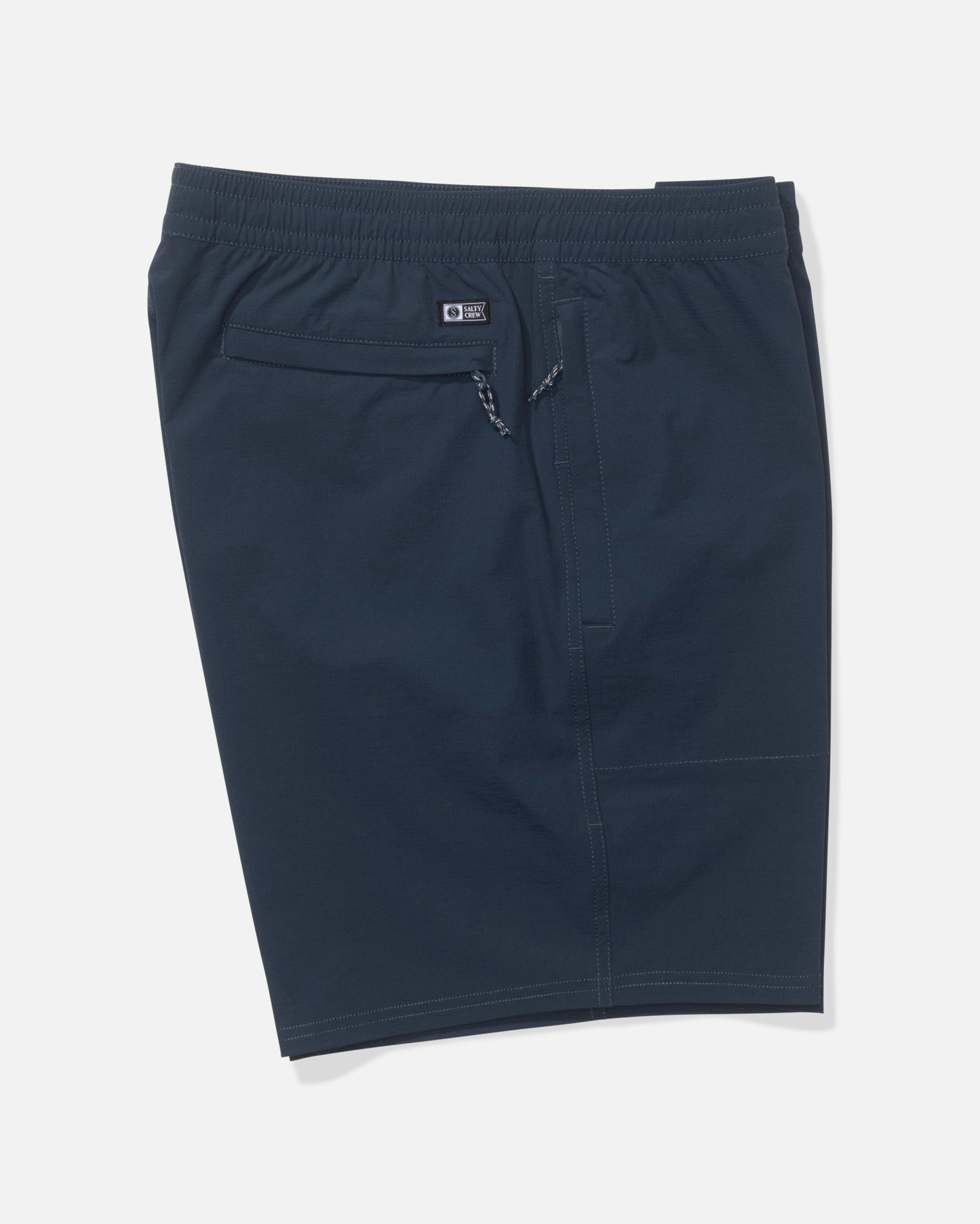 The Salty Crew Crew 18" Ewaist Boatshort in navy features an elastic waistband, front drawstring, back zippered pocket, and quick dry ripstop fabric, shown laid flat on a white background.