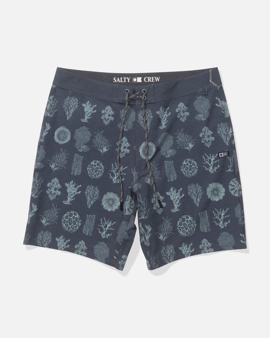 The Salty Crew 19" Crew Boardshort in Magnet features a navy blue base with a light blue coral and sea life pattern, a drawstring waist, 4-way stretch comfort fabric, and Salty Crew branding on the inner waistband.