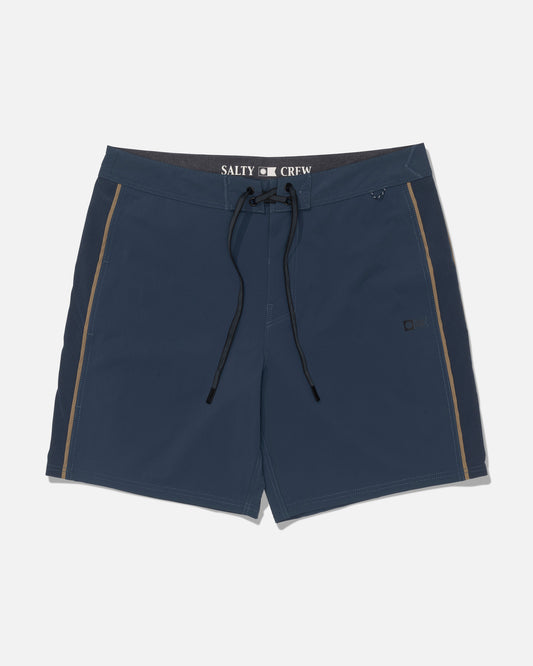 The Salty Crew Channel 18″ Apex Boardshort in navy features a black drawstring, tan side stripes, and Salty Crew branding on the inner waistband. Crafted from 4-way stretch quick-dry fabric for ultimate comfort, these straight-leg performance shorts are shown against a white background.