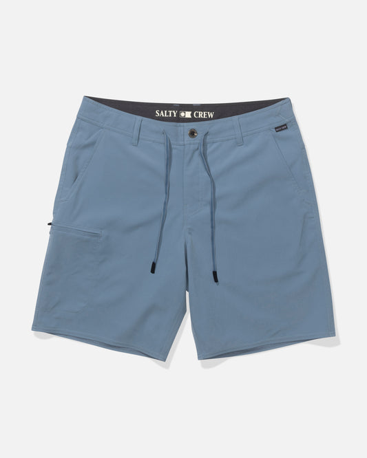 The Salty Crew Transom 19" Tech Short in Pilot Blue is made from quick-dry, lightweight 4-way stretch fabric. Features include a drawstring waist, belt loops, multiple pockets, and interior SALTY CREW branding. Shown on a white background.