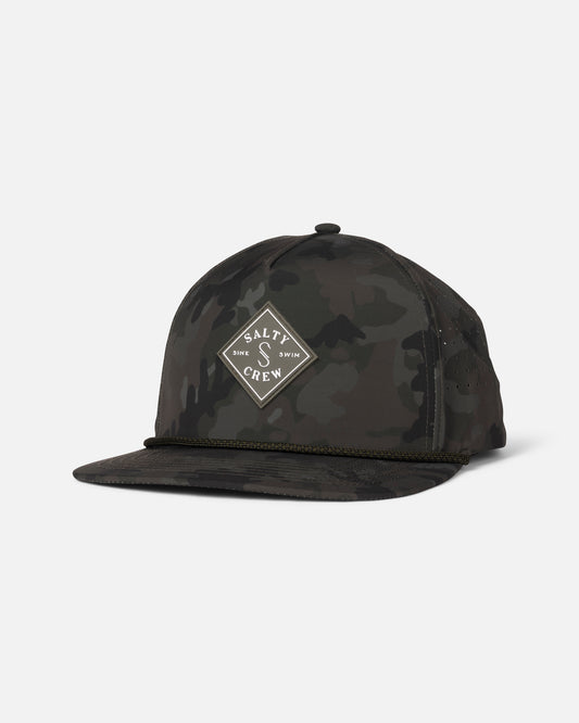 The Salty Crew Long Range Tech Snapback - Camo is a black and dark green camo flat-brim cap with a diamond-shaped logo patch on the front.