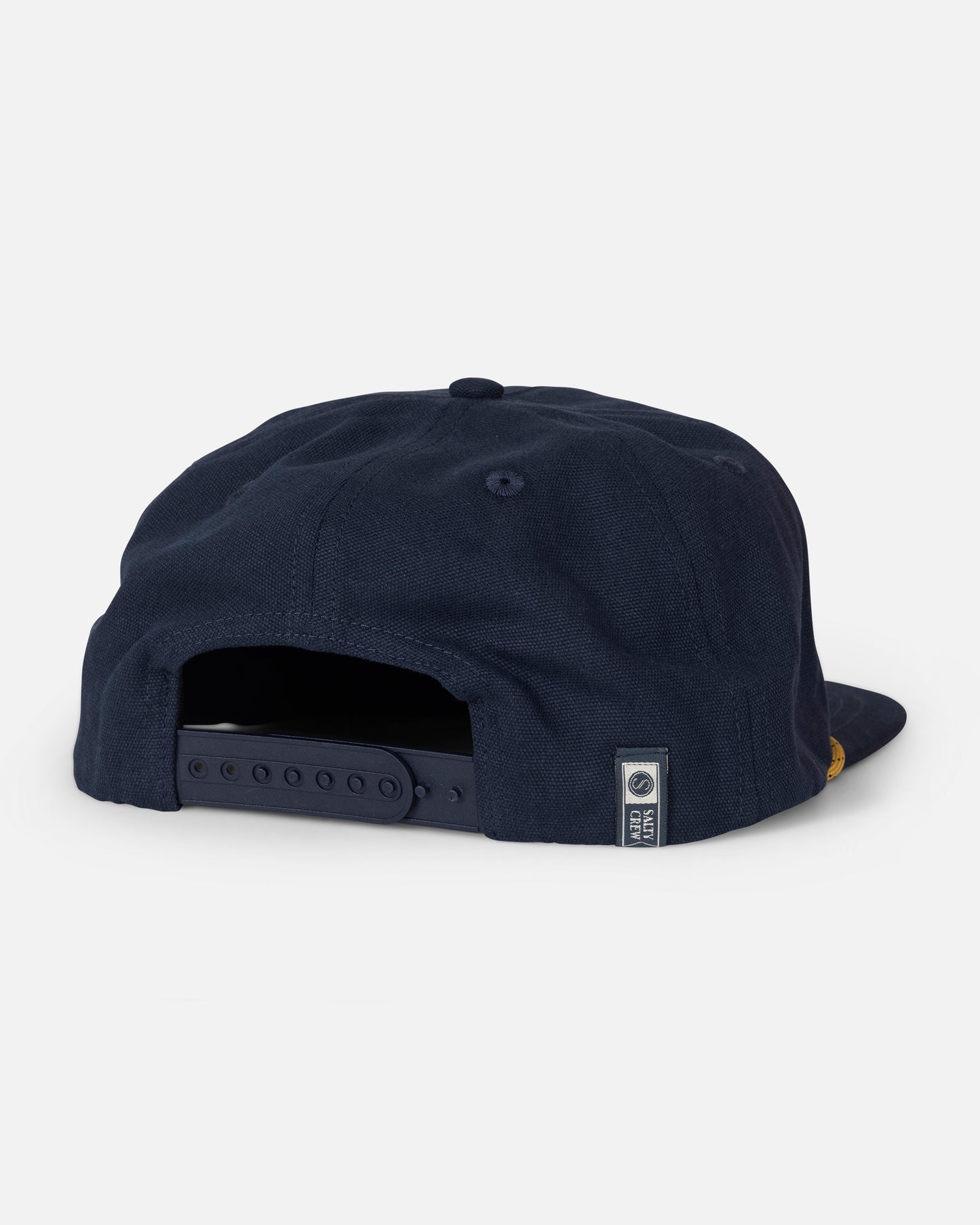 A back view of the Salty Crew Coastal Snapback - Navy shows an adjustable strap and a small rectangular tag on the lower edge. This classic cotton 5-panel cap combines casual style with a comfortable fit and features embroidered detailing.