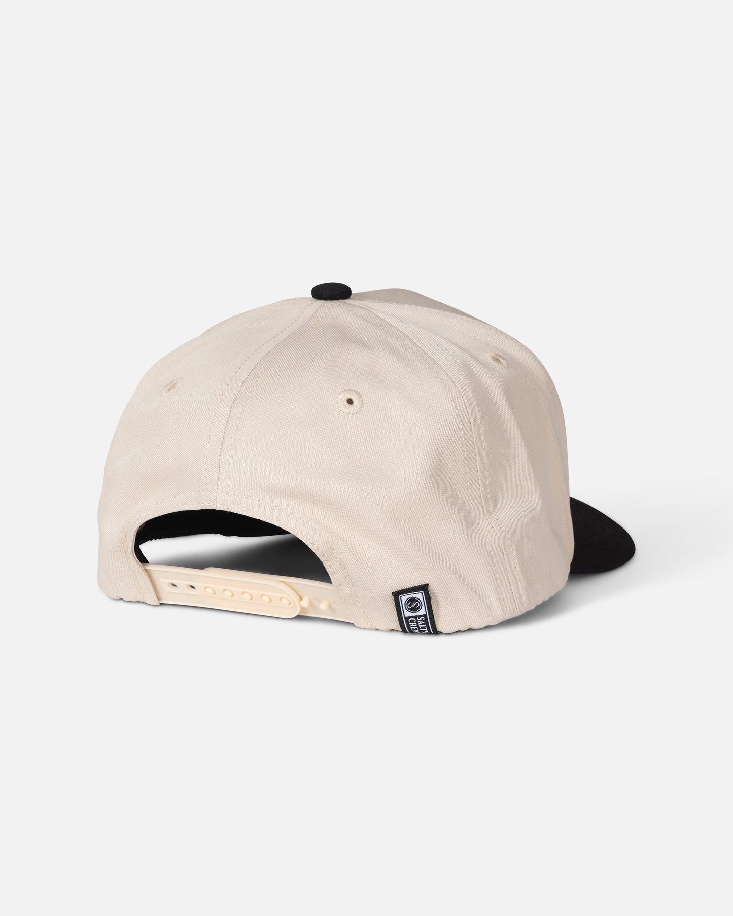 The Salty Crew Reel Repair Snapback in Off White/Black is a structured 5-panel baseball cap, shown from the back with an adjustable snapback closure and a small logo tag near the opening. Made from durable cotton canvas, it offers everyday comfort.