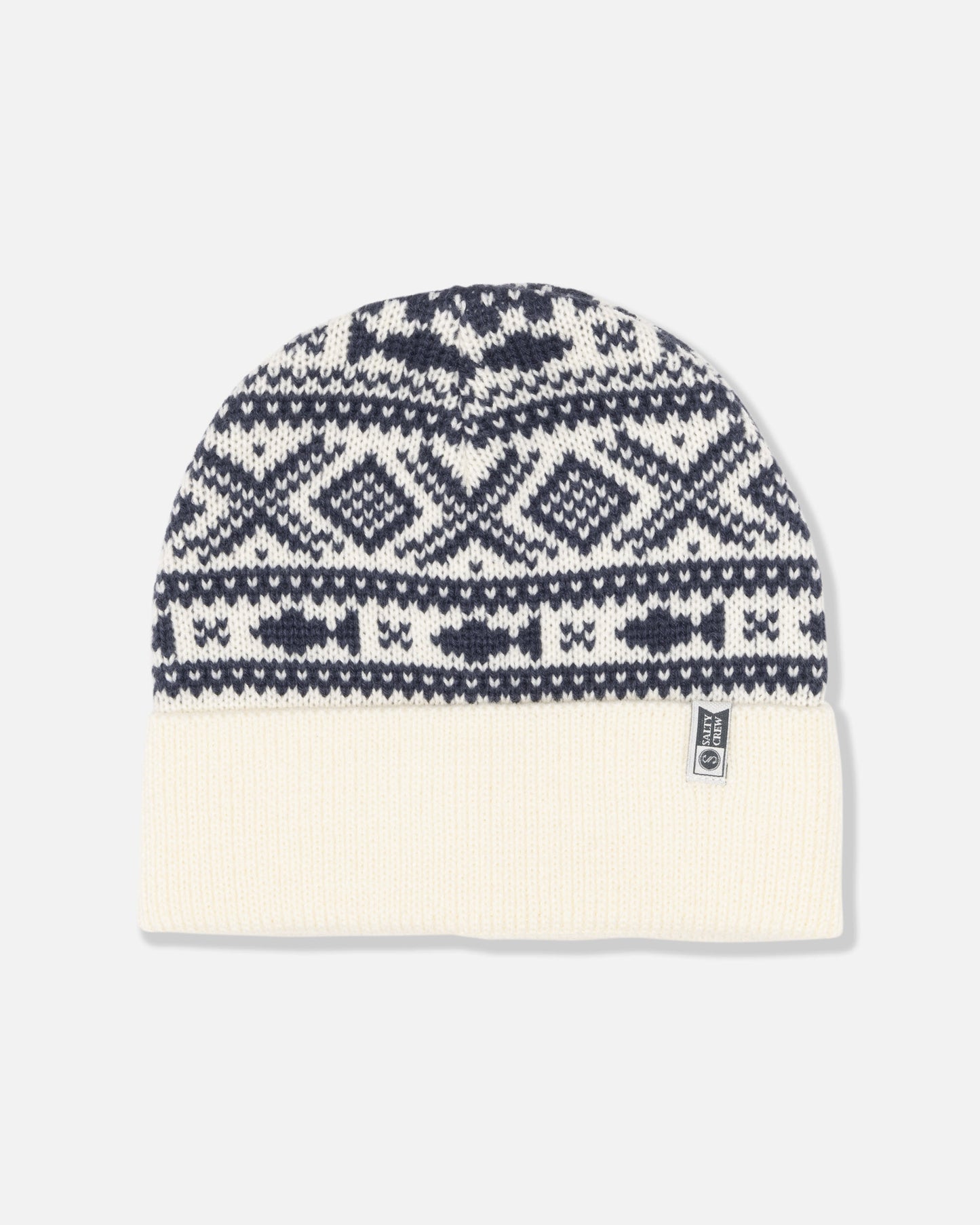 The Out To Sea Beanie - Off White by Salty Crew features a black and white geometric jacquard pattern with a solid off-white turnback cuff, finished with a small rectangular brand tag on the brim.