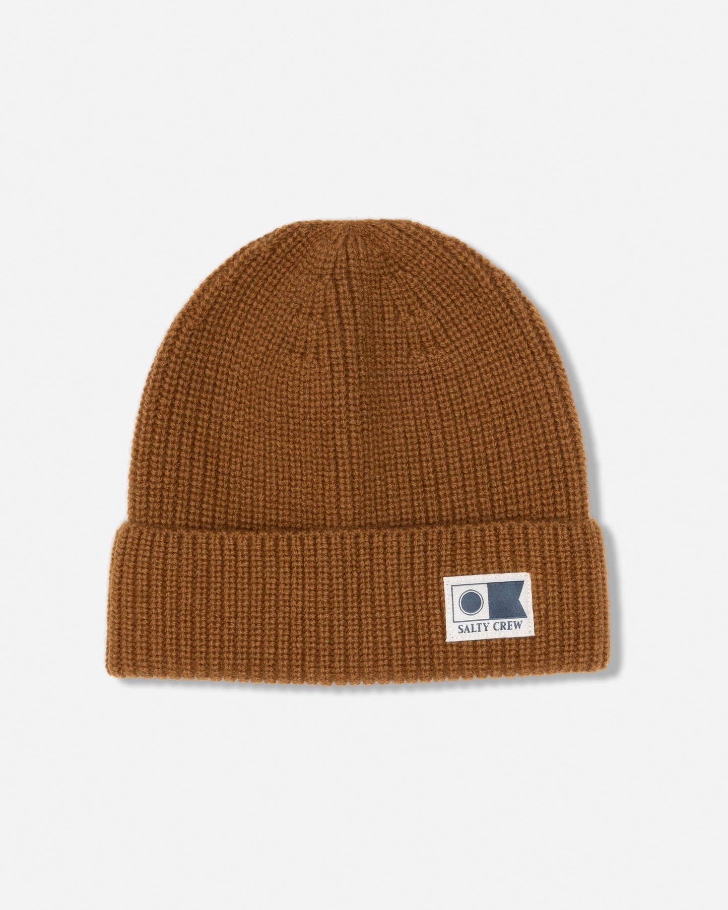 The Refuge Wool Beanie - Bronze Brown by Salty Crew is a brown knit cuff beanie with a folded brim, featuring a rectangular patch with a simple logo and the Salty Crew text on the front. Crafted from wool, this watch cap features classic six-dart construction for enhanced durability and shape. The beanie is shown against a white background.