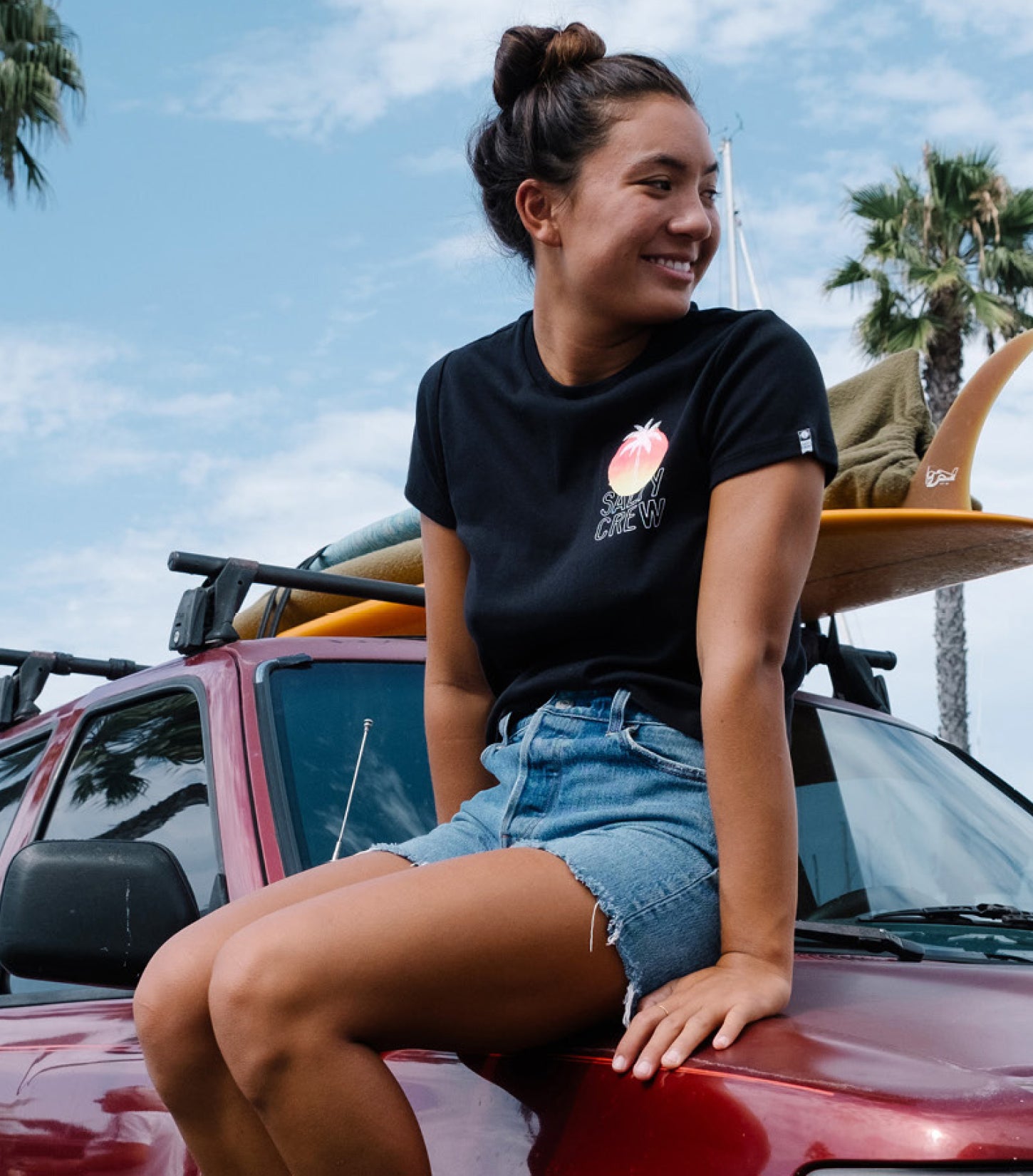 Lifestyle shot of model sitting on car