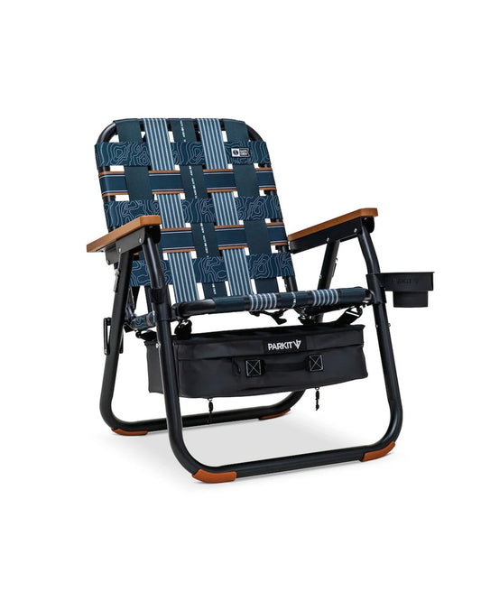 The PARKIT Co. Parkit x Salty Crew Voyager Chair features blue patterned fabric, wooden armrests, a black frame, built-in cooler, right-side cup holder, and an attached storage pouch for the Waterman lifestyle.