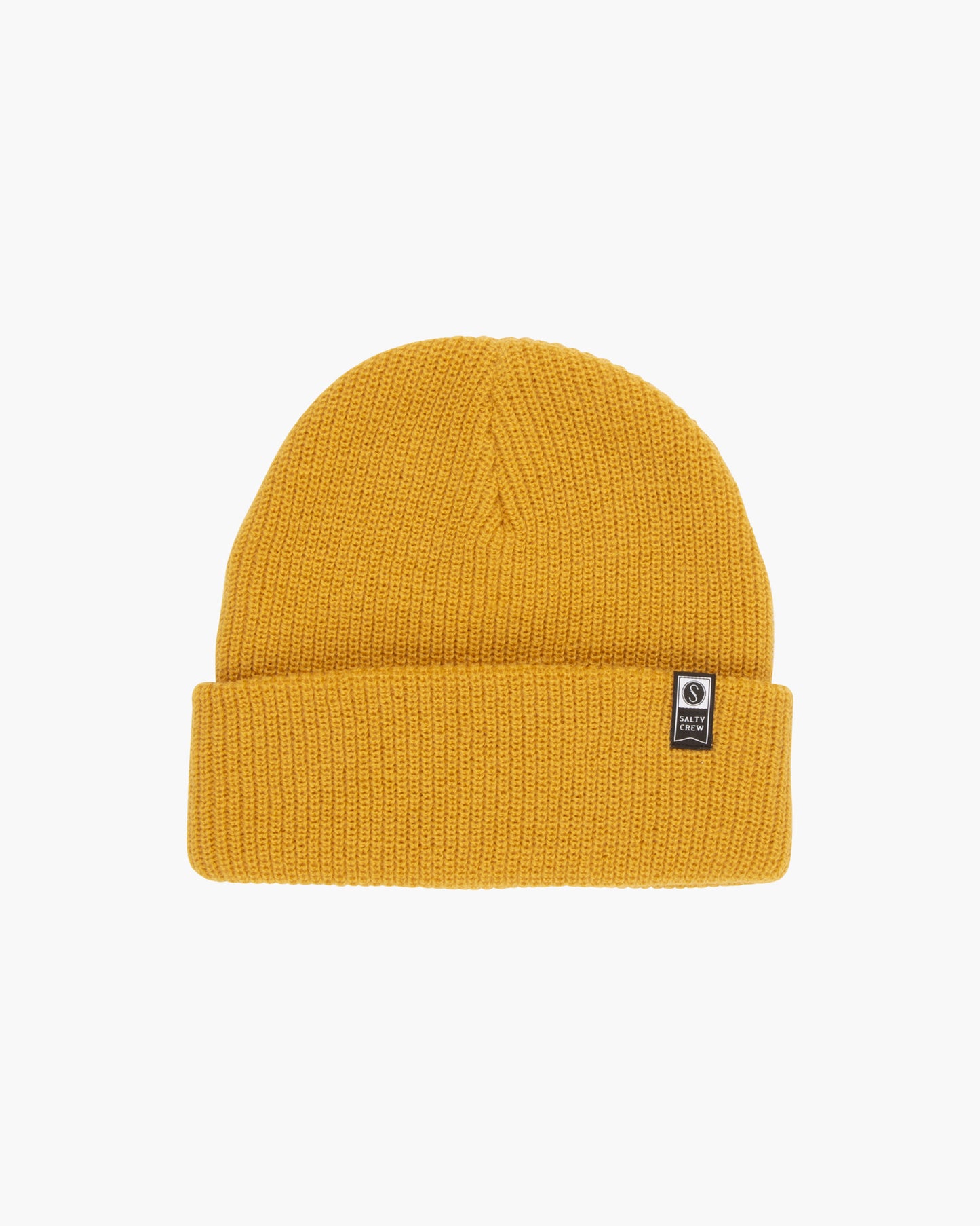 The Salty Crew Alpha Ochre Beanie is a classic mustard yellow acrylic knit with a folded brim and a small black and white brand tag on the front, displayed against a plain white background.
