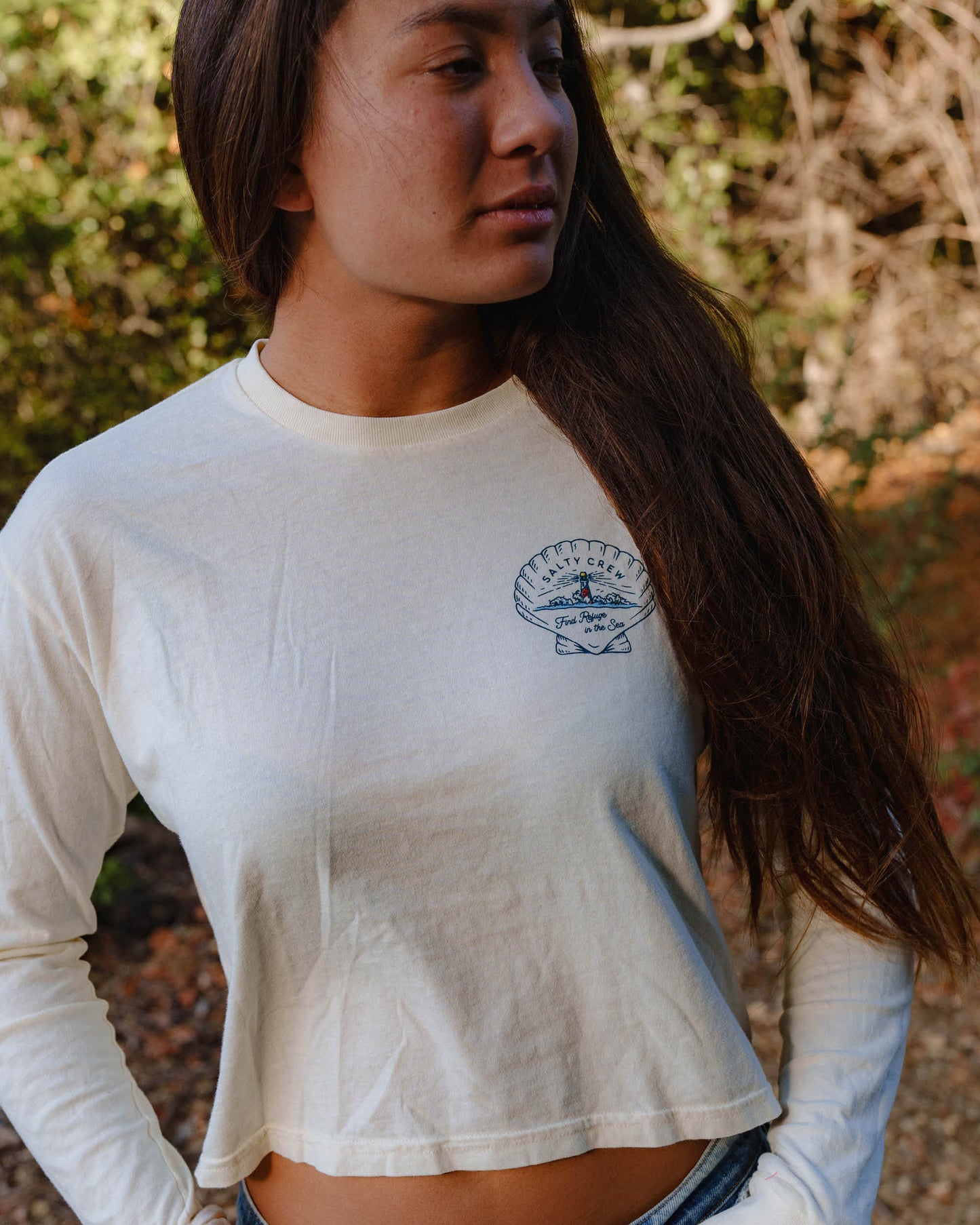Lifestyle shot of the Scallop Long Sleeve Crop Tee - Off White. 