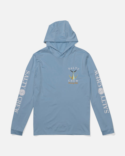 The Salty Crew Tailed Hood Sunshirt - Clear Sky is a light blue hooded shirt with UPF 50+, white SALTY CREW print on both sleeves, and a left chest logo featuring a yellow fish and Salty Crew text.