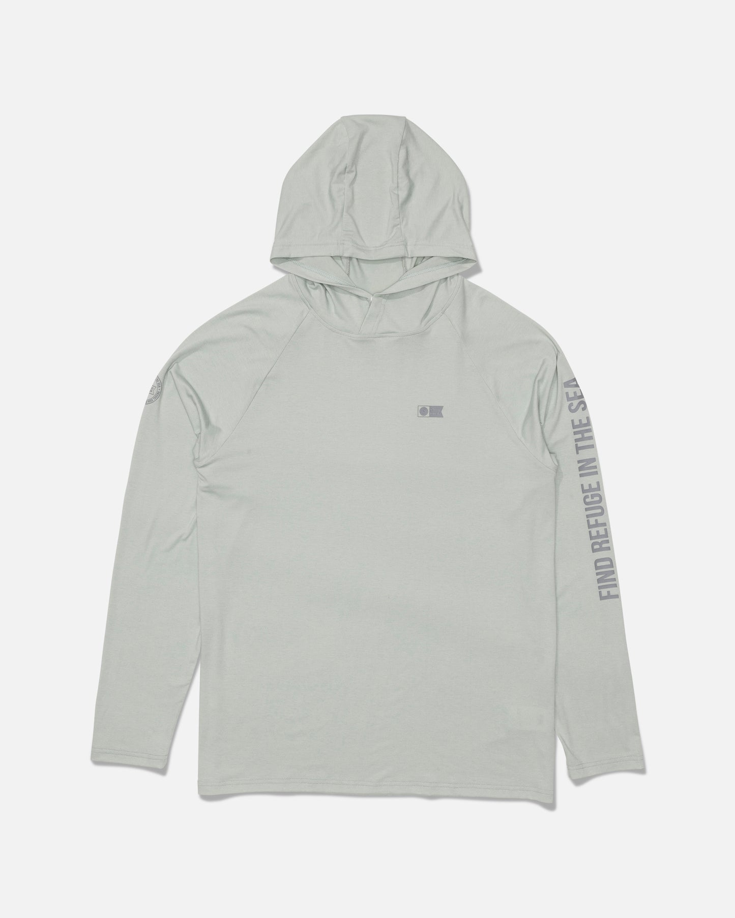 The Salty Crew Mariner Lite UV Hood in Aqua Grey is a light gray hooded long-sleeve shirt featuring a subtle Salty Crew logo on the chest and “FIND REFUGE IN THE SEA” text printed along the right sleeve. Made from recycled polyester for sustainability, this shirt is shown laid flat on a white background.