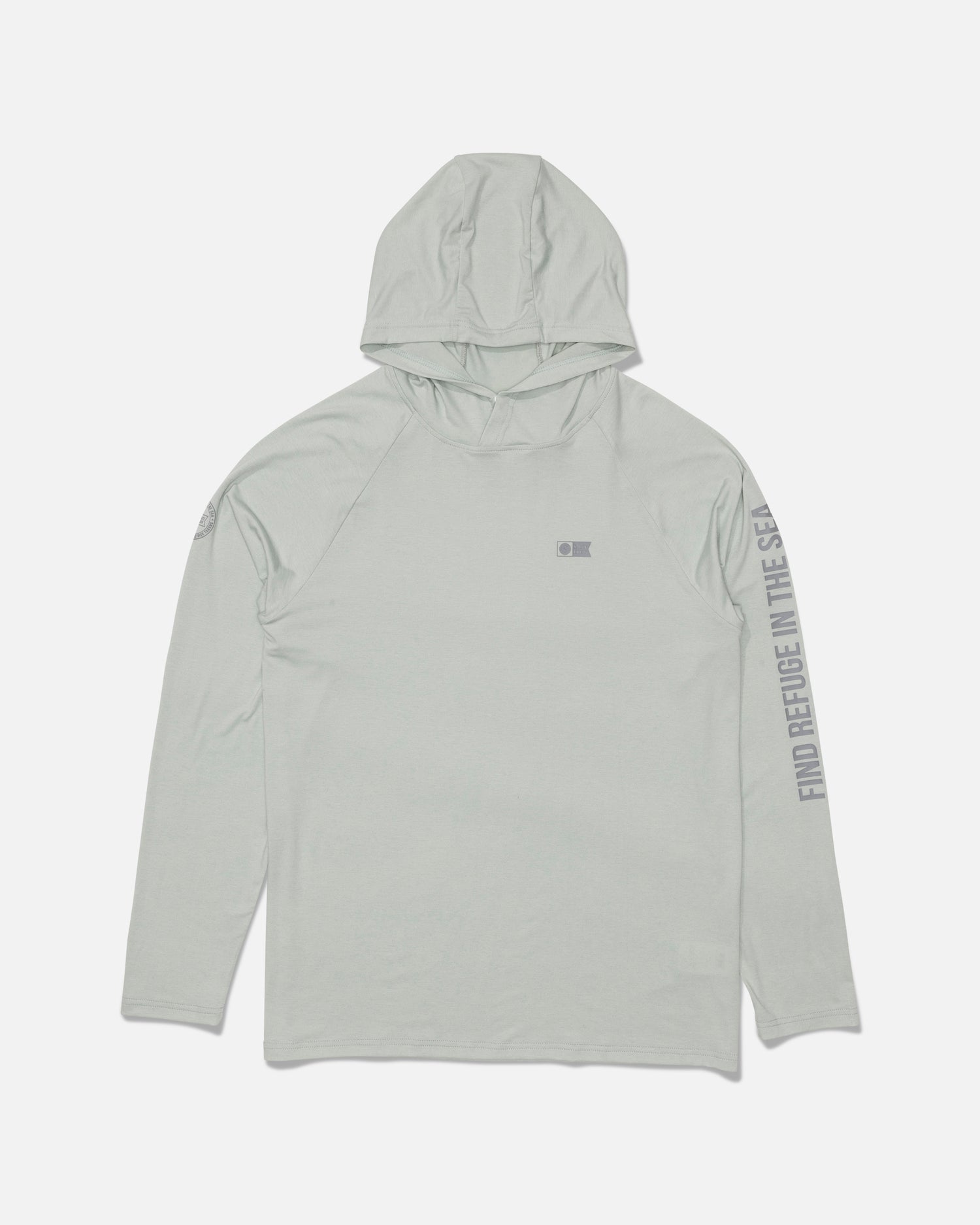 The Salty Crew Mariner Lite UV Hood in Aqua Grey is a light gray hooded long-sleeve shirt featuring a subtle Salty Crew logo on the chest and “FIND REFUGE IN THE SEA” text printed along the right sleeve. Made from recycled polyester for sustainability, this shirt is shown laid flat on a white background.