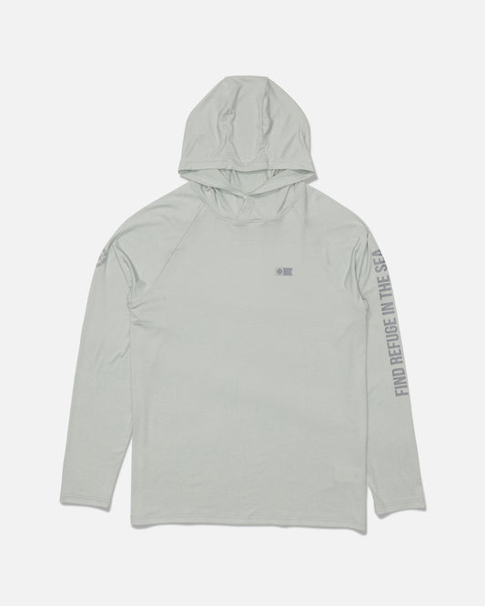 The Salty Crew Mariner Lite UV Hood in Aqua Grey is a light gray hooded long-sleeve shirt featuring a subtle Salty Crew logo on the chest and “FIND REFUGE IN THE SEA” text printed along the right sleeve. Made from recycled polyester for sustainability, this shirt is shown laid flat on a white background.