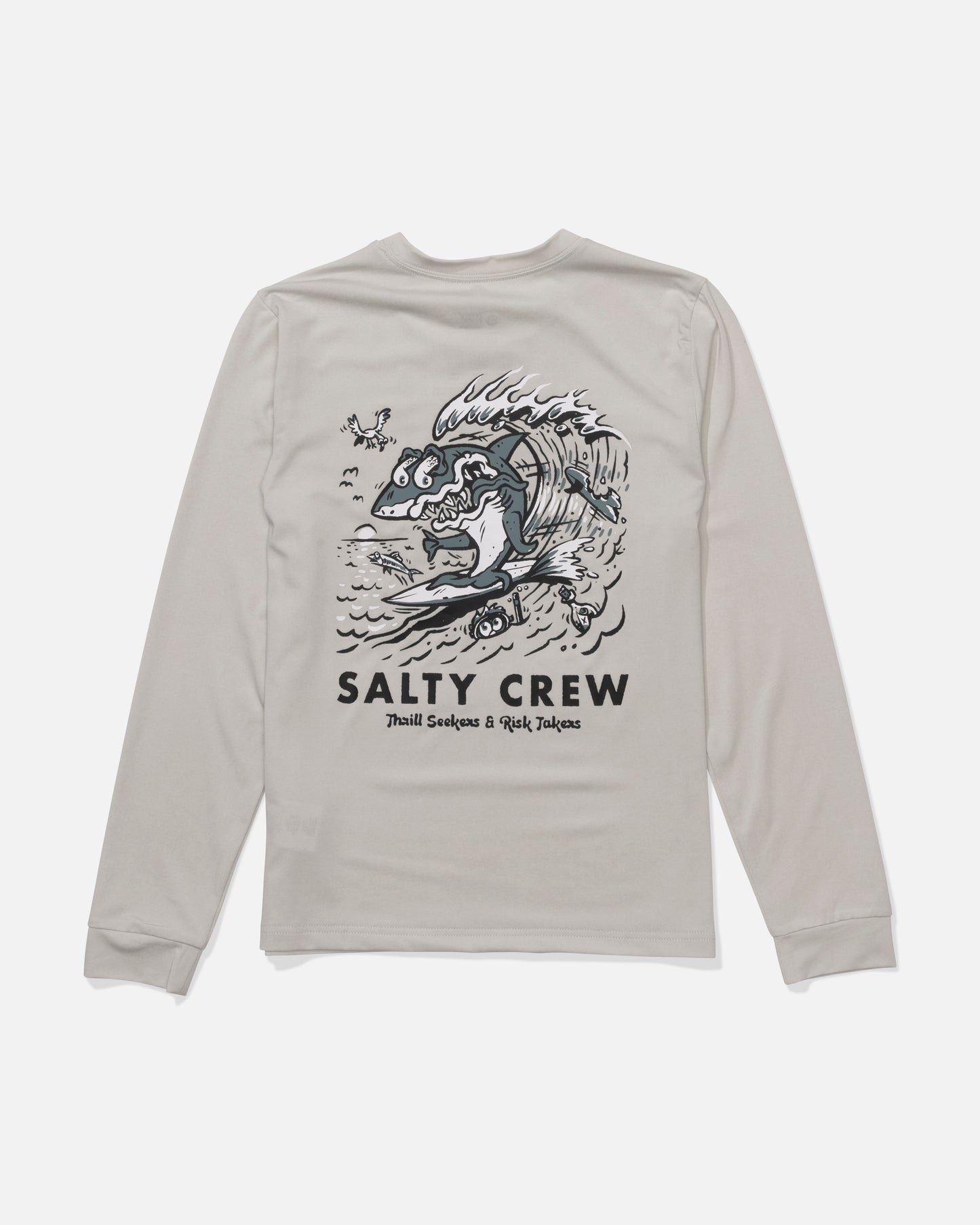 The Salty Crew Surf Shark Boys Sunshirt in Athletic Heather is a light gray, moisture-wicking tee with UPF 50+ protection. Features a back graphic of a surfing fish with birds and water, plus "SALTY CREW" and "Thrill Seekers & Risk Takers" text.