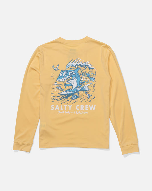 The Salty Crew Surf Shark Boys Sunshirt in light orange features a blue and white leaping fish graphic with "Salty Crew" boldly below and “Thrill Seekers & Risk Takers” in smaller text. UPF 50+ sun protection keeps adventurers safe all day.