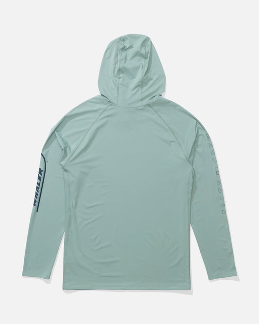 The Salty Crew Whaler Apex Perforated Sunshirt - Mackerel is a light blue-green long-sleeve hooded shirt with dark blue graphics on the left sleeve, offering UPF 50+ sun protection and breathable, lightweight performance comfort.