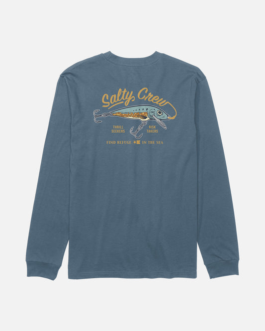 The Salty Crew Decoy Long Sleeve Tee in Slate features a blue cotton construction with a fish lure graphic on the back, “Salty Crew” text above, and the phrases “Thrill Seekers,” “Risk Takers,” and “Find Refuge in the Sea” screenprinted below.