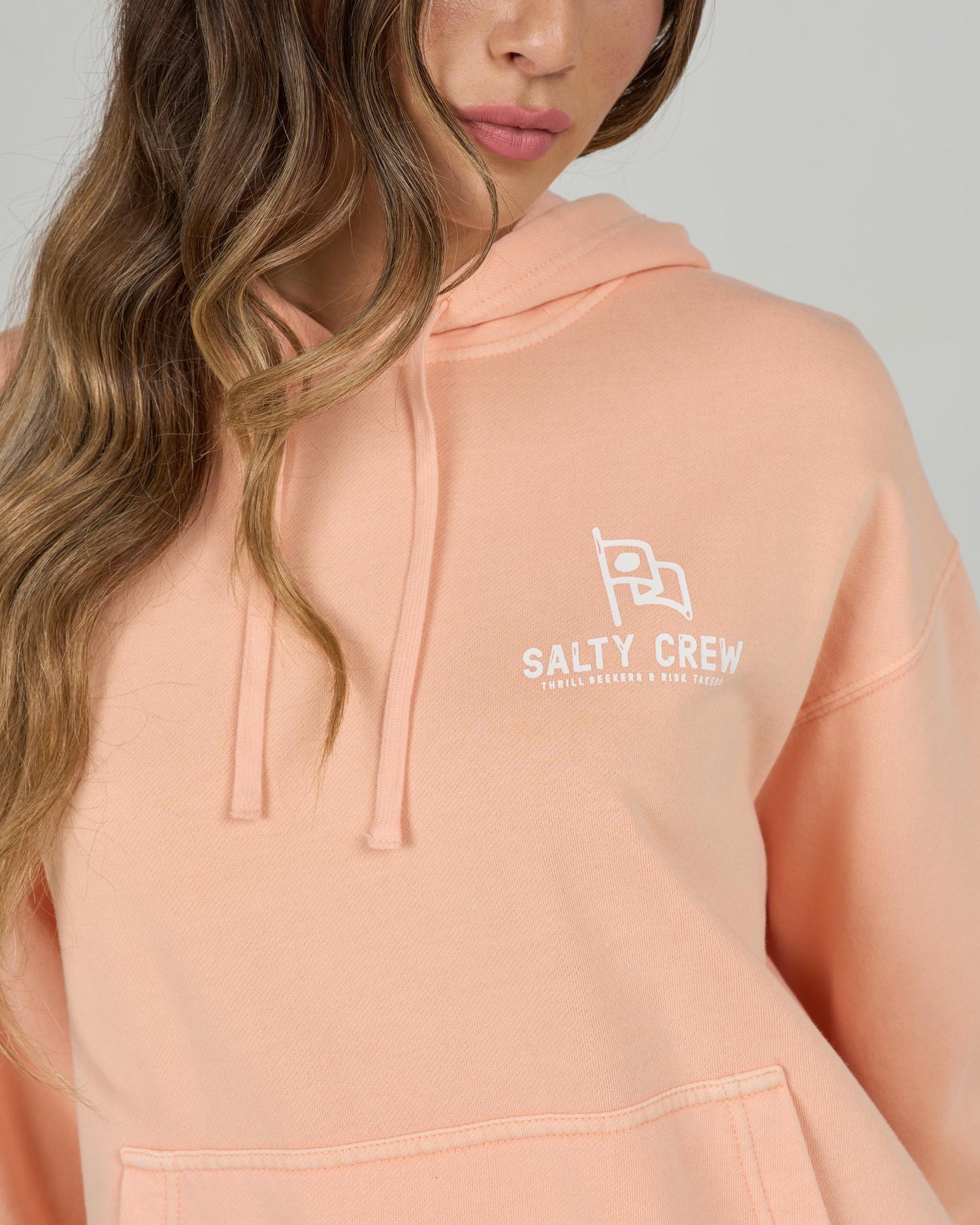 Close up view of the Flying High Hoody - Apricot. 