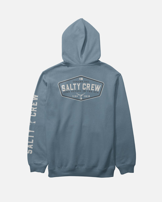 Here’s the rewritten sentence using your product data: The Salty Crew Tailfin Fleece in Slate is a mid-weight cotton-polyester hoodie featuring SALTY CREW printed in white on the back and sleeve, along with a logo and the phrase “FIND REFUGE IN THE SEA SINK OR SWIM.” It includes a hood, long sleeves, and a comfortable screenprinted finish.