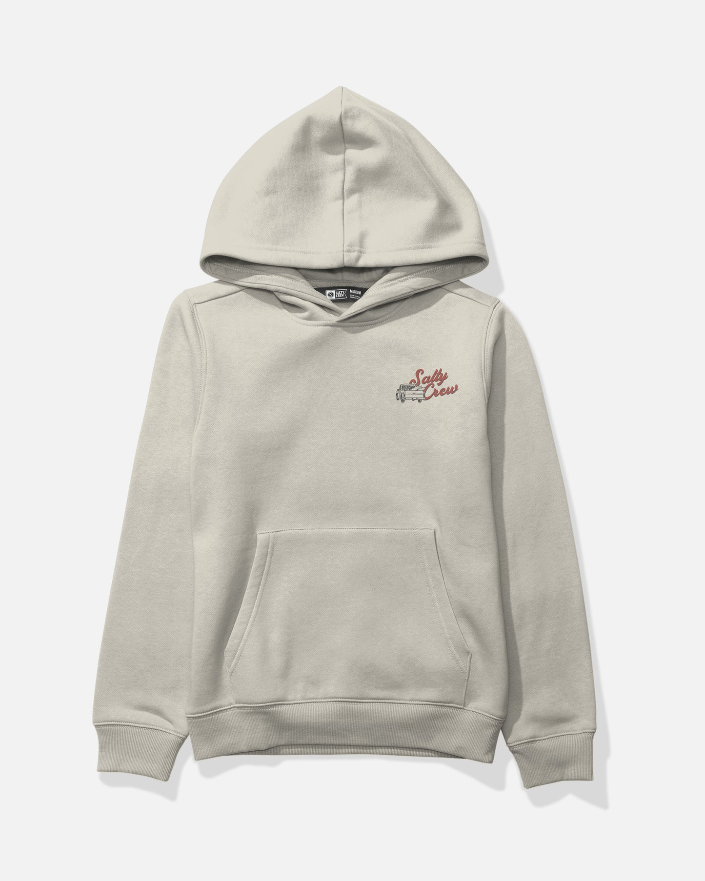 The Salty Crew Truck Bed Boys Fleece - Bone is a light beige mid-weight cotton-polyester hoodie featuring a front kangaroo pocket. A small, screenprinted graphic of a vintage pickup truck and “Salty Crew” in red script accents the left chest, all set against a plain white background for lasting style.