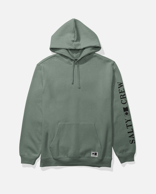 The Refuge Fleece - Laurel Wreath by Salty Crew is a sage green mid weight hoodie crafted from a comfortable cotton-polyester blend, featuring an adjustable drawstring hood and a handy kangaroo pocket. It displays “SALTY CREW” printed in black on the right sleeve and includes a small rectangular logo near the pocket.