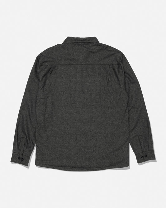 The Salty Crew Fathom Tech Shacket in Agave—a dark gray, long-sleeve, mid-weight twill shirt with button cuffs—is shown laid flat with the back facing up against a plain white background.
