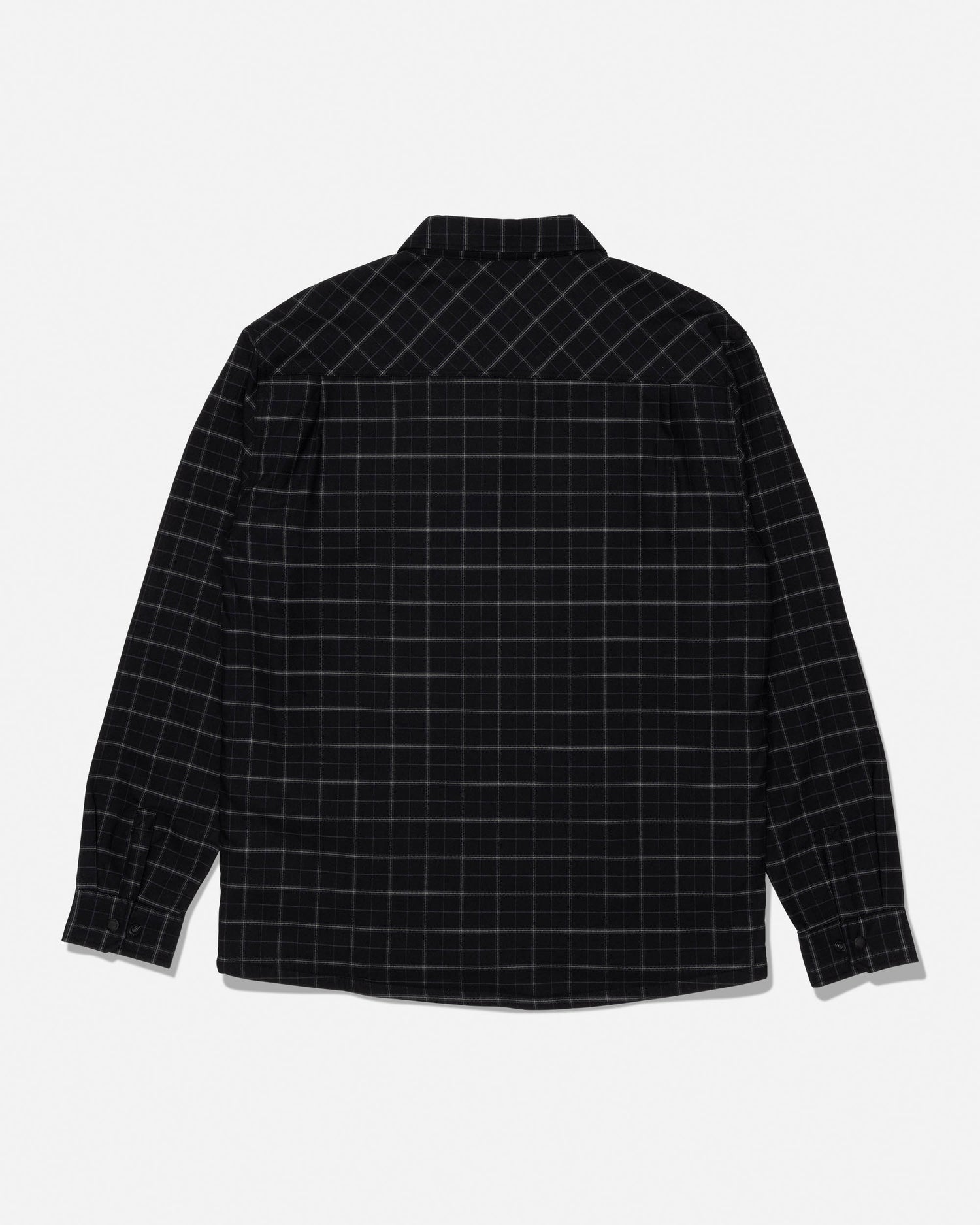 The Salty Crew Fathom Tech Shacket in Black/Green is displayed laid flat to showcase the back side. This long-sleeve, button-up shacket features a black base with a subtle green grid plaid pattern and is crafted from mid-weight twill with a cozy polar fleece liner for warmth and comfort.