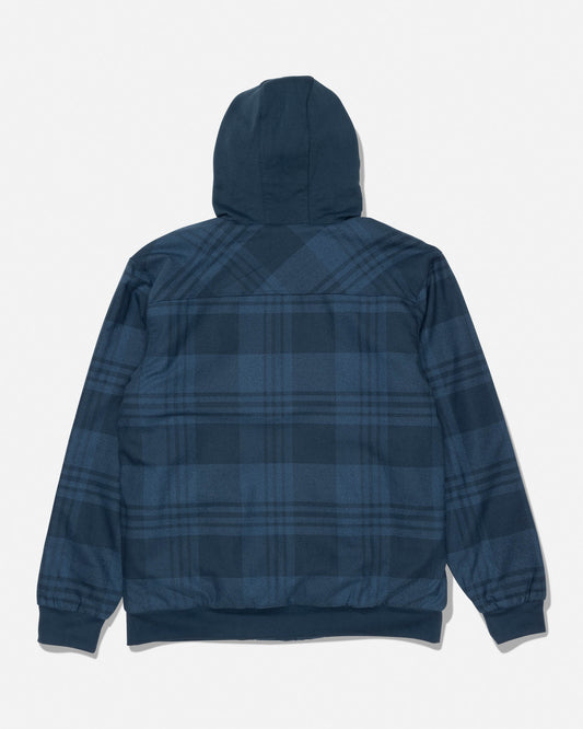 The Salty Crew Fathom Jacket in Mid Blue is shown from the back, featuring a blue plaid pattern, long sleeves with ribbed cuffs and a waistband. This mid-weight twill jacket is lined with cozy grid fleece for added warmth and comfort.