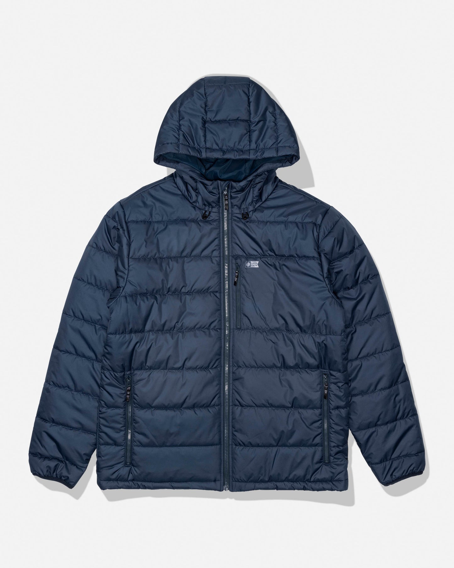 The Salty Crew Barrier Hooded Jacket in navy features quilted stitching, an insulated hood, a front zipper closure, two zippered side pockets, and a small chest logo, shown against a light background.