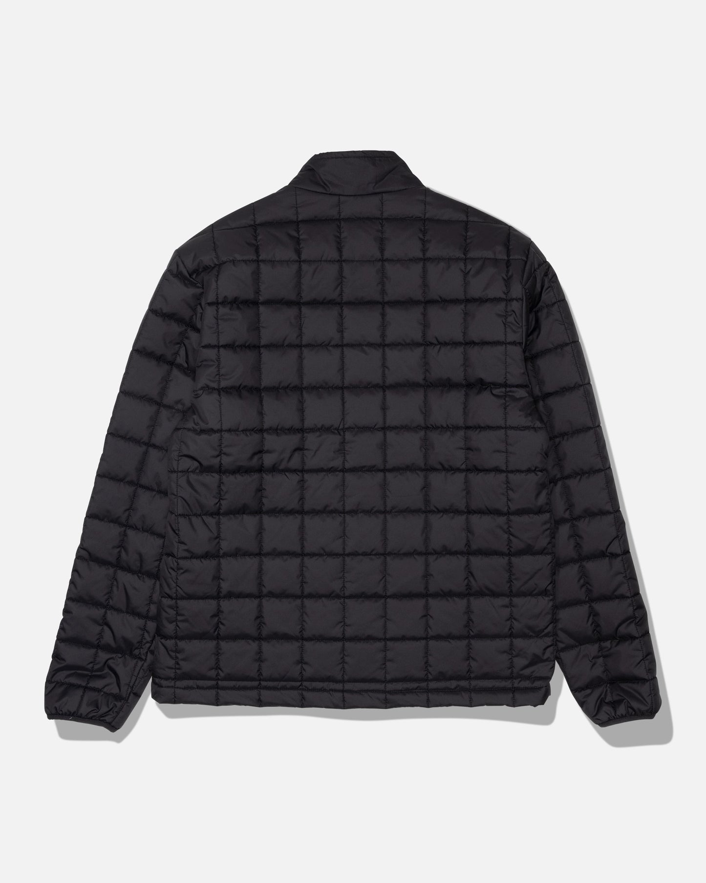 The Salty Crew Barrier Lite Jacket - Black is displayed from the back against a plain white background. This jacket features a black quilted grid pattern, long sleeves, and a simple collar, and is crafted with lightweight synthetic fill for comfort.