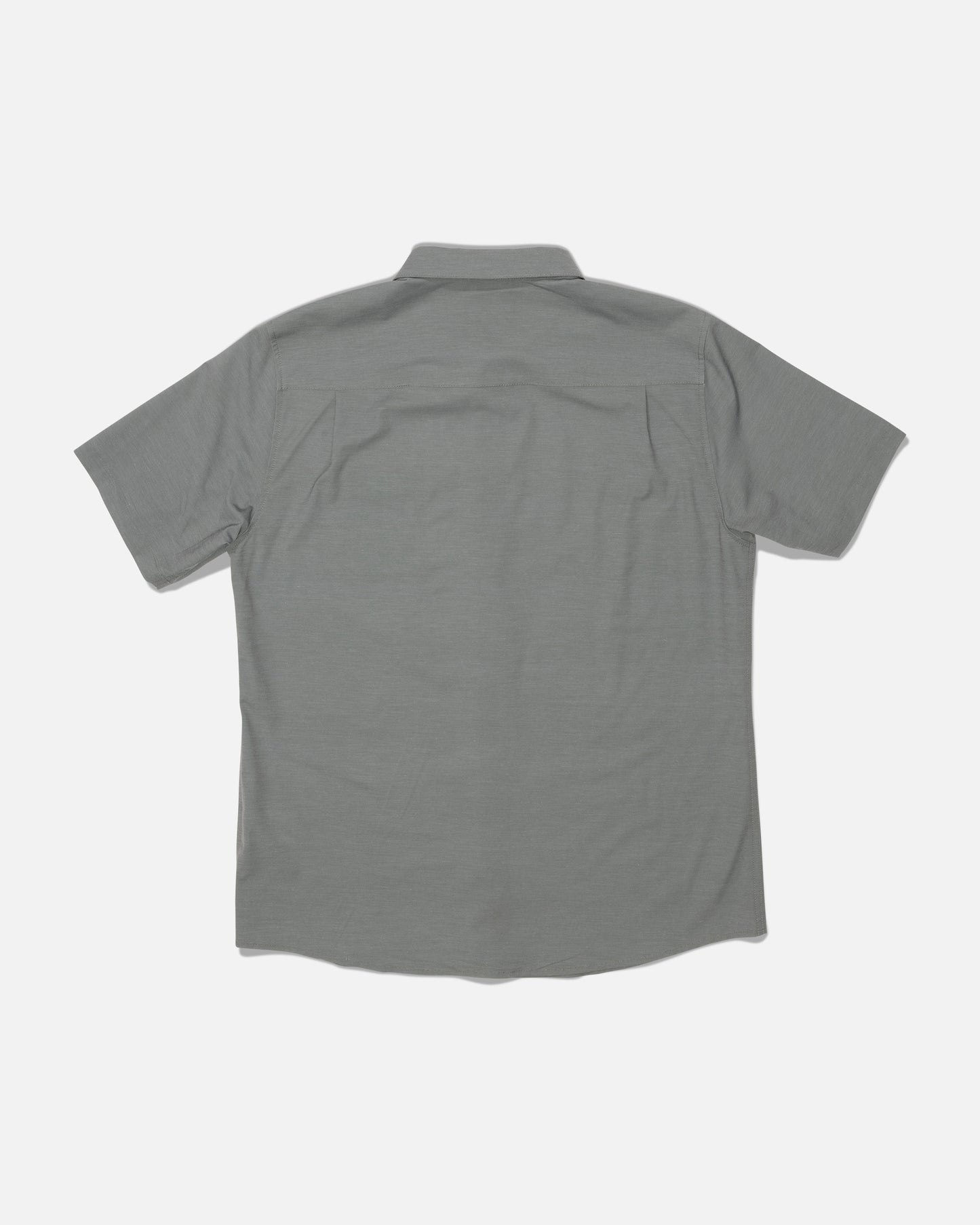 The Salty Crew Drifter UV Button Up in Agave is displayed from the back on a white background. This gray short-sleeve shirt features a collar and a clean design with no visible logos or patterns. Made with quick dry fabric and advanced moisture wicking technology, it’s designed to keep you comfortable all day long.