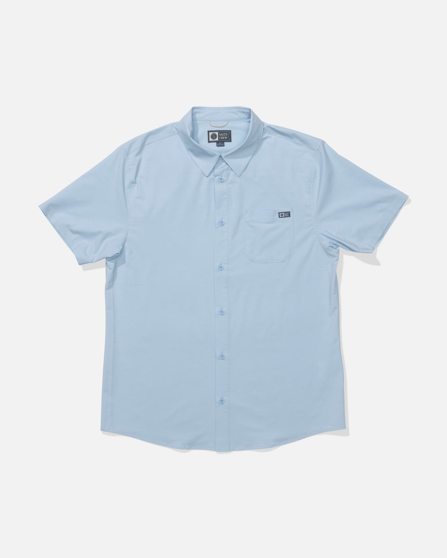 The Salty Crew Drifter UV Button Up in Clear Sky is a light blue, short-sleeve collared shirt with a left chest pocket. Made from moisture-wicking, quick-dry fabric for all-day comfort. Displayed on a white background.