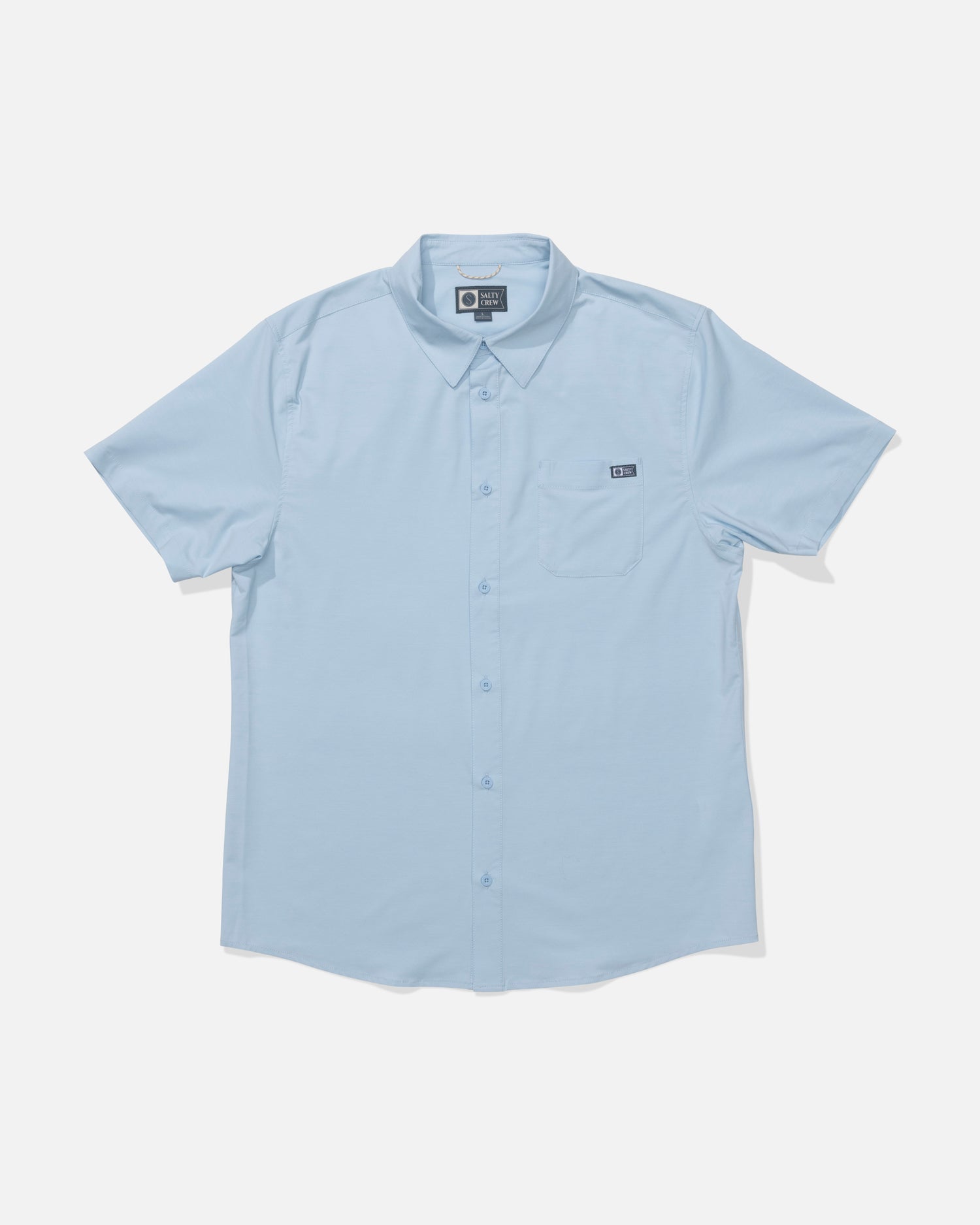 The Salty Crew Drifter UV Button Up in Clear Sky is a light blue, short-sleeve collared shirt with a left chest pocket. Made from moisture-wicking, quick-dry fabric for all-day comfort. Displayed on a white background.