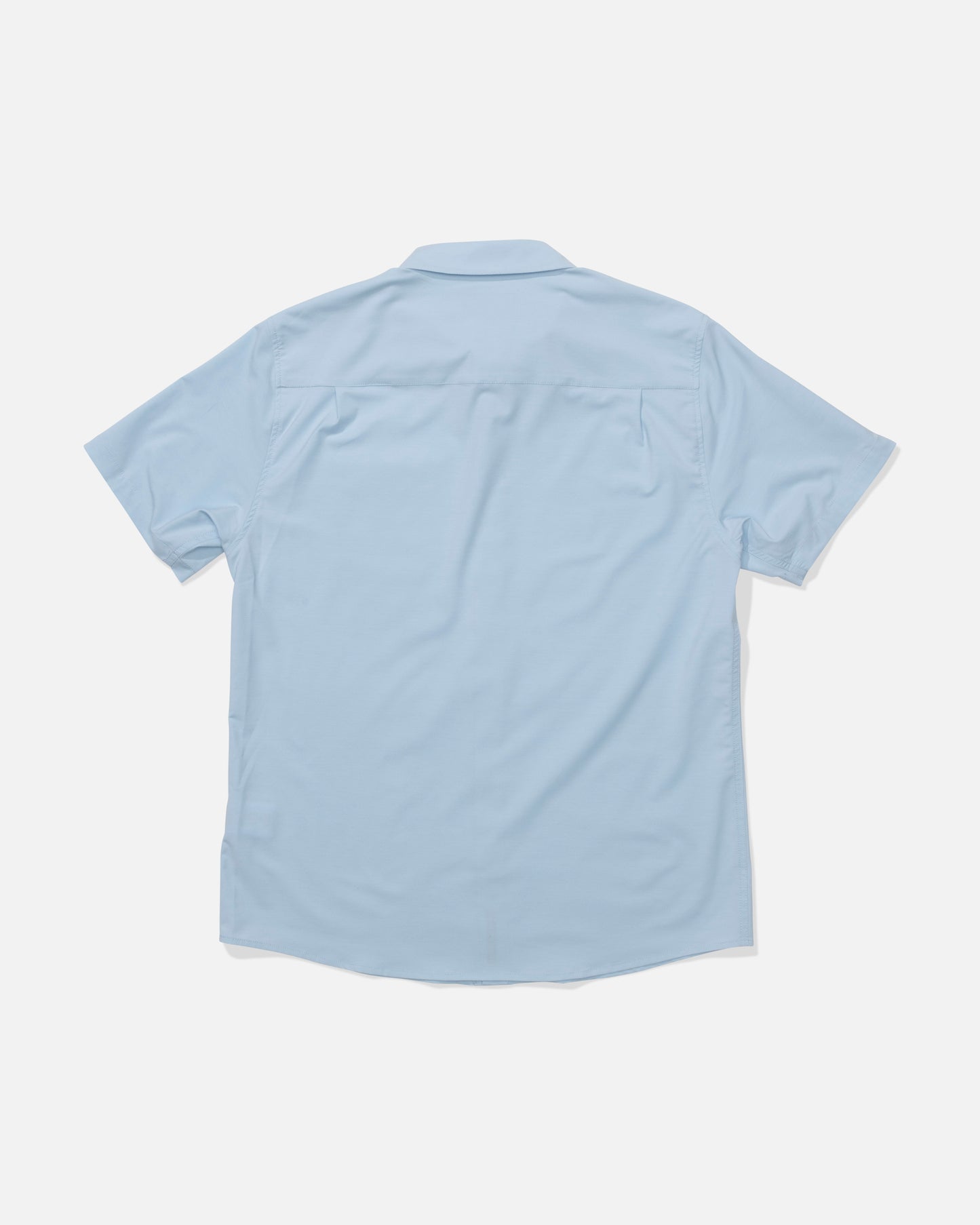 The Salty Crew Drifter UV Button Up in Clear Sky is a light blue short-sleeve shirt, shown from the back, laid flat on white. It features a collar, quick-dry comfort for all-day wear, and has no visible patterns or logos.