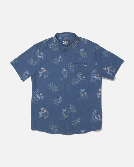 Salty Crew Drifter UV Button Up in Navy, a short-sleeve shirt with a floral pattern and front pocket, features UPF 50+ sun protection to help guard against harmful rays and is displayed laid flat on a white background.