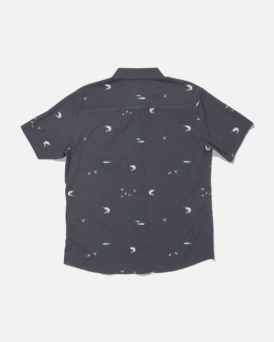 The Salty Crew Flagship UV Button Up in Dark Grey features small embroidered moons, birds, and fish scattered across the back. Crafted with quick-dry, moisture-wicking fabric that offers UPF 50+ sun protection, this short-sleeve shirt is designed to keep you cool and comfortable all day long. The shirt is displayed laid flat on a white background, showing the back side.