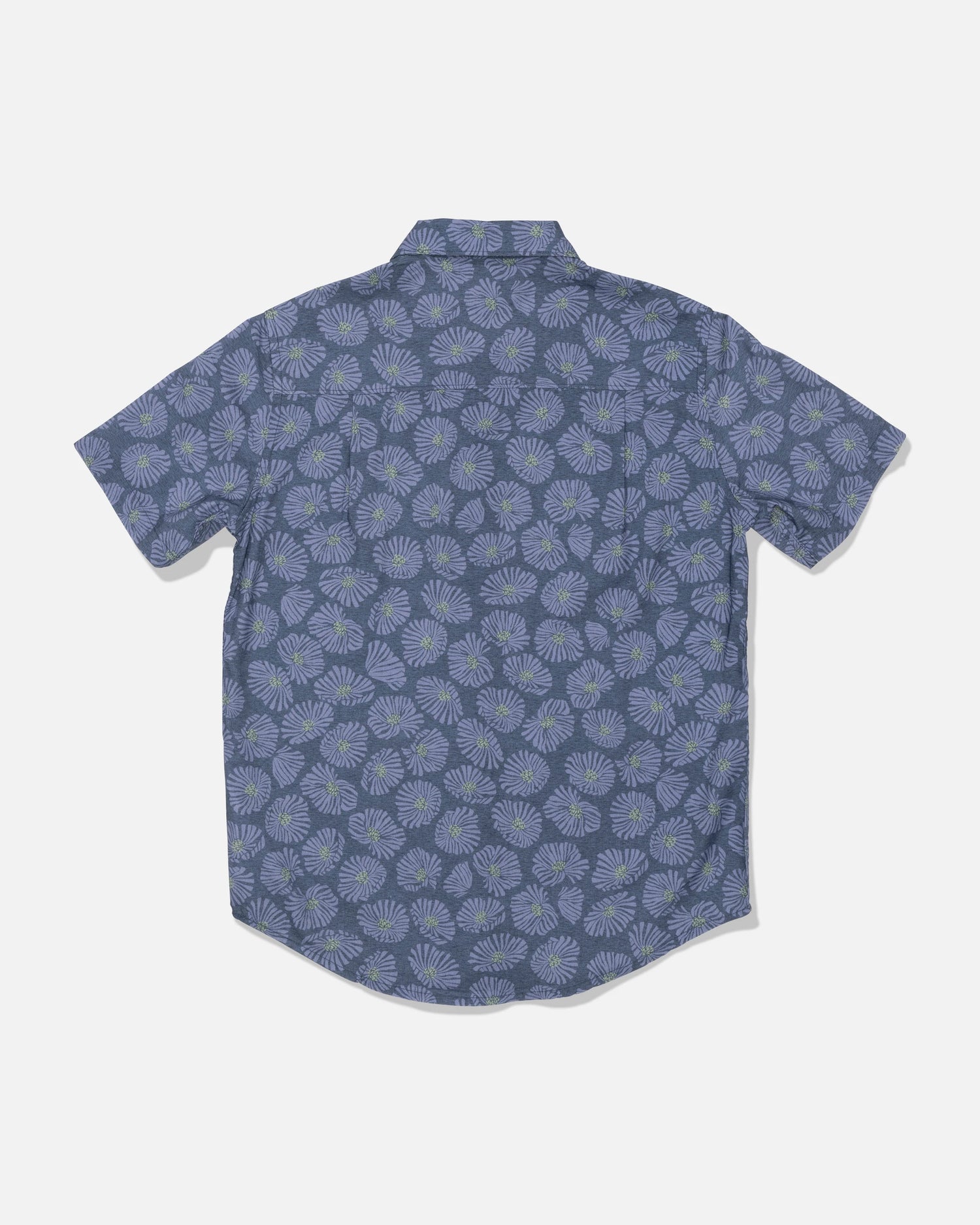 The Salty Crew Crew Boys Button Up in Hitch Blue is a short-sleeve, button-up shirt made from a soft cotton blend, featuring an allover print of light blue and green floral designs on a blue background. The shirt is displayed from the back against a plain white backdrop.