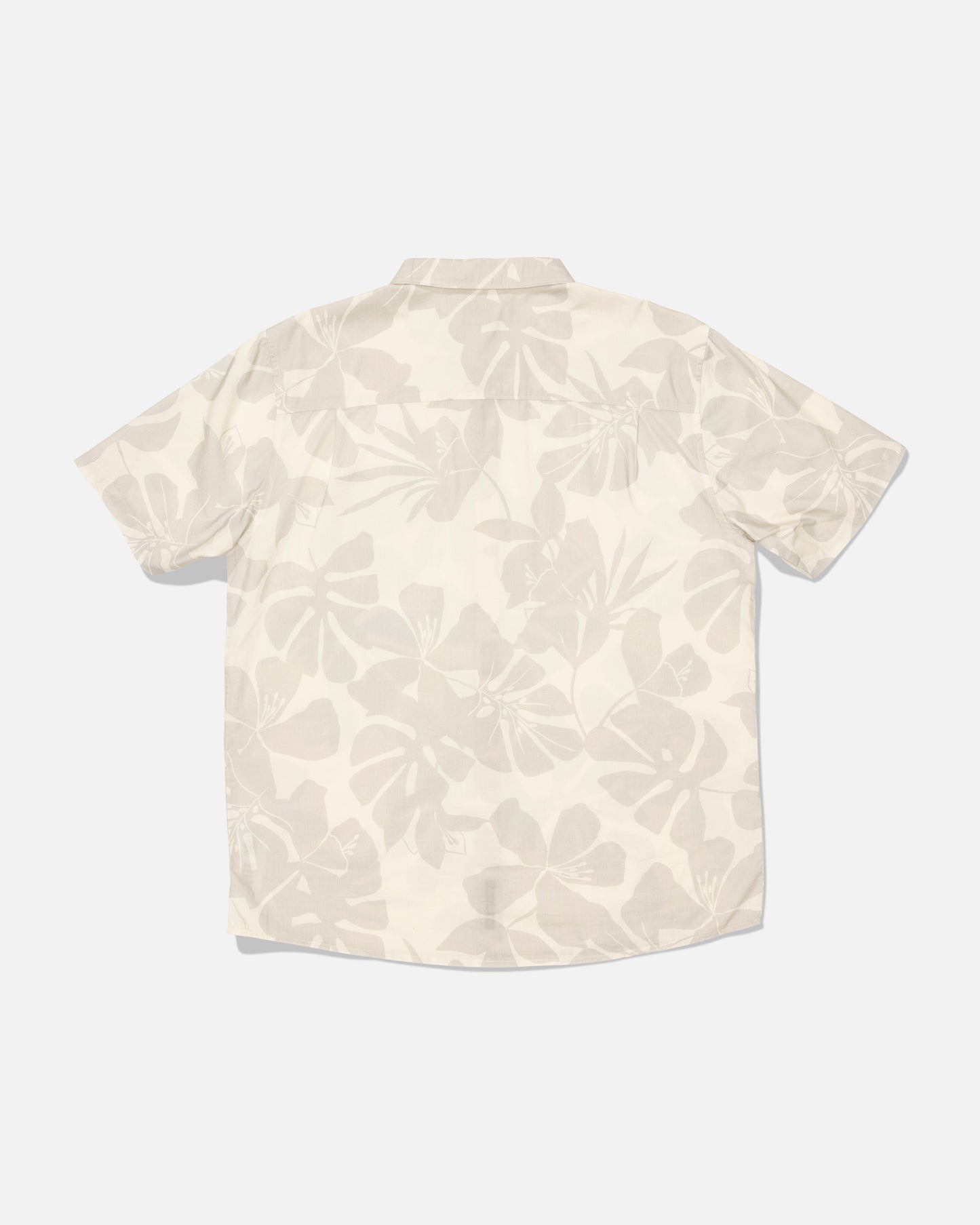 The Salty Crew “Crew Button Up - Birch” is a short-sleeve shirt made from a cotton blend, featuring a light beige and white allover floral print. Shown from the back against a plain white background, this shirt has been garment washed for enhanced softness and a relaxed feel.