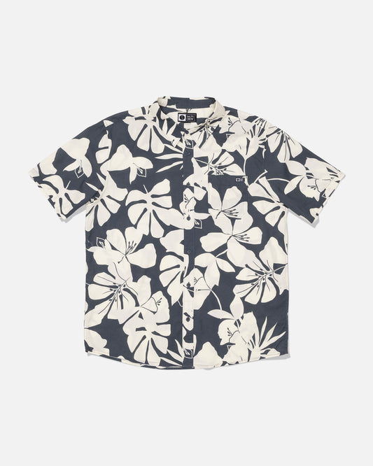Salty Crew Crew Button Up - Iron: A short-sleeve button-up shirt made from a soft cotton blend, showcasing a bold white tropical allover print on a black background, displayed flat against a plain white surface.